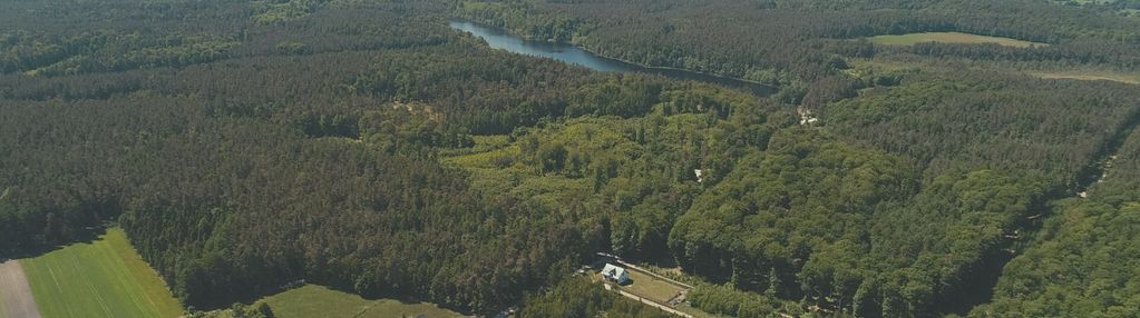 Płaska działka w sąsiedztwie jeziora i lasów