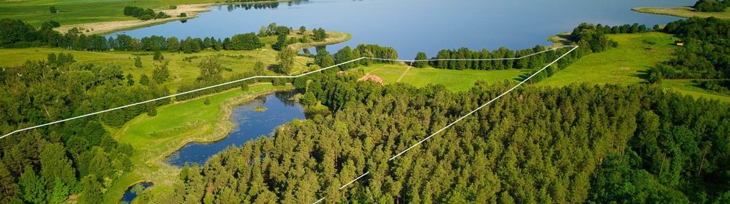 Działka nad jeziorem z lasem, stawem i domem