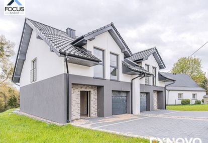 Nowy dom z garażem i ogrodem.