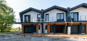 Skrajna szeregówka w zieleni – garaż i taras.